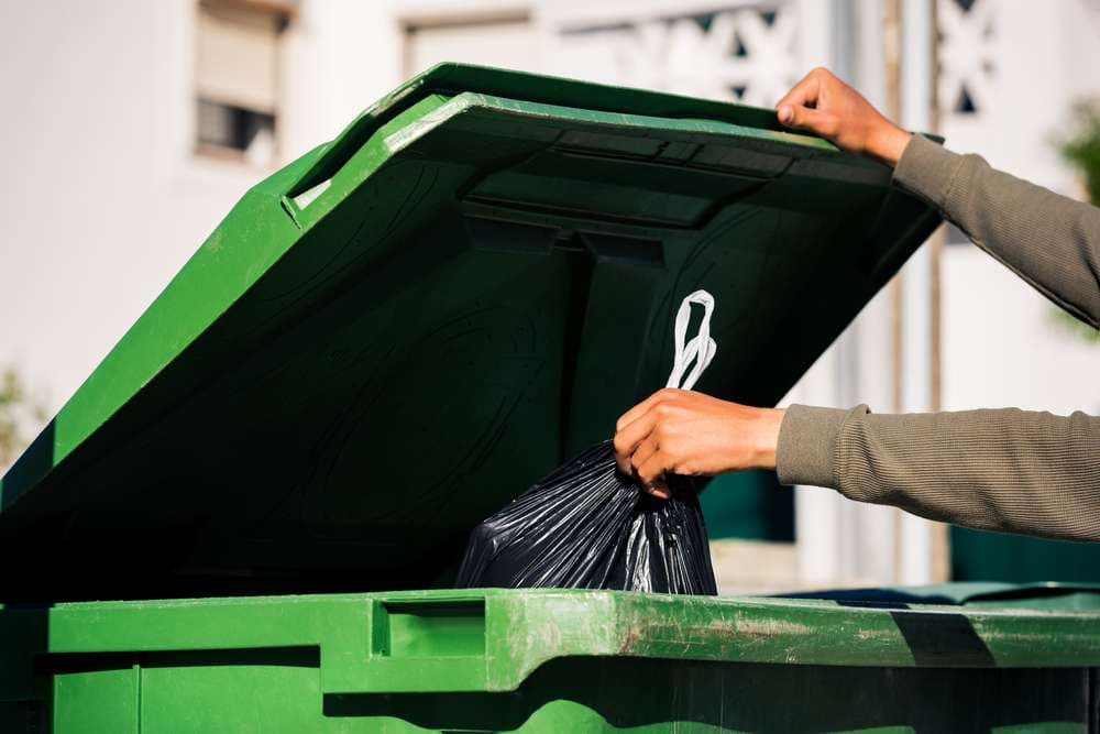 man-throwing-out-black-ecofriendly-recyclable man-throwing-out-black-ecofriendly-recyclable